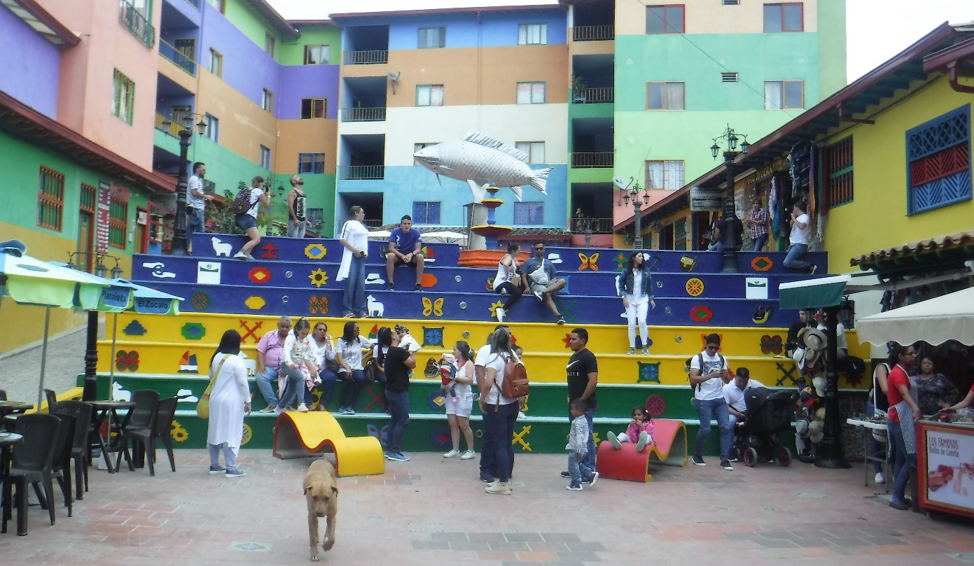 A group of people standing in front of a building Description automatically generated