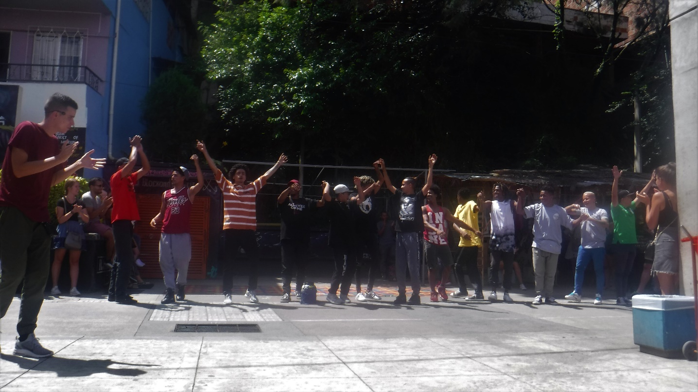 A group of people standing in front of a building Description automatically generated