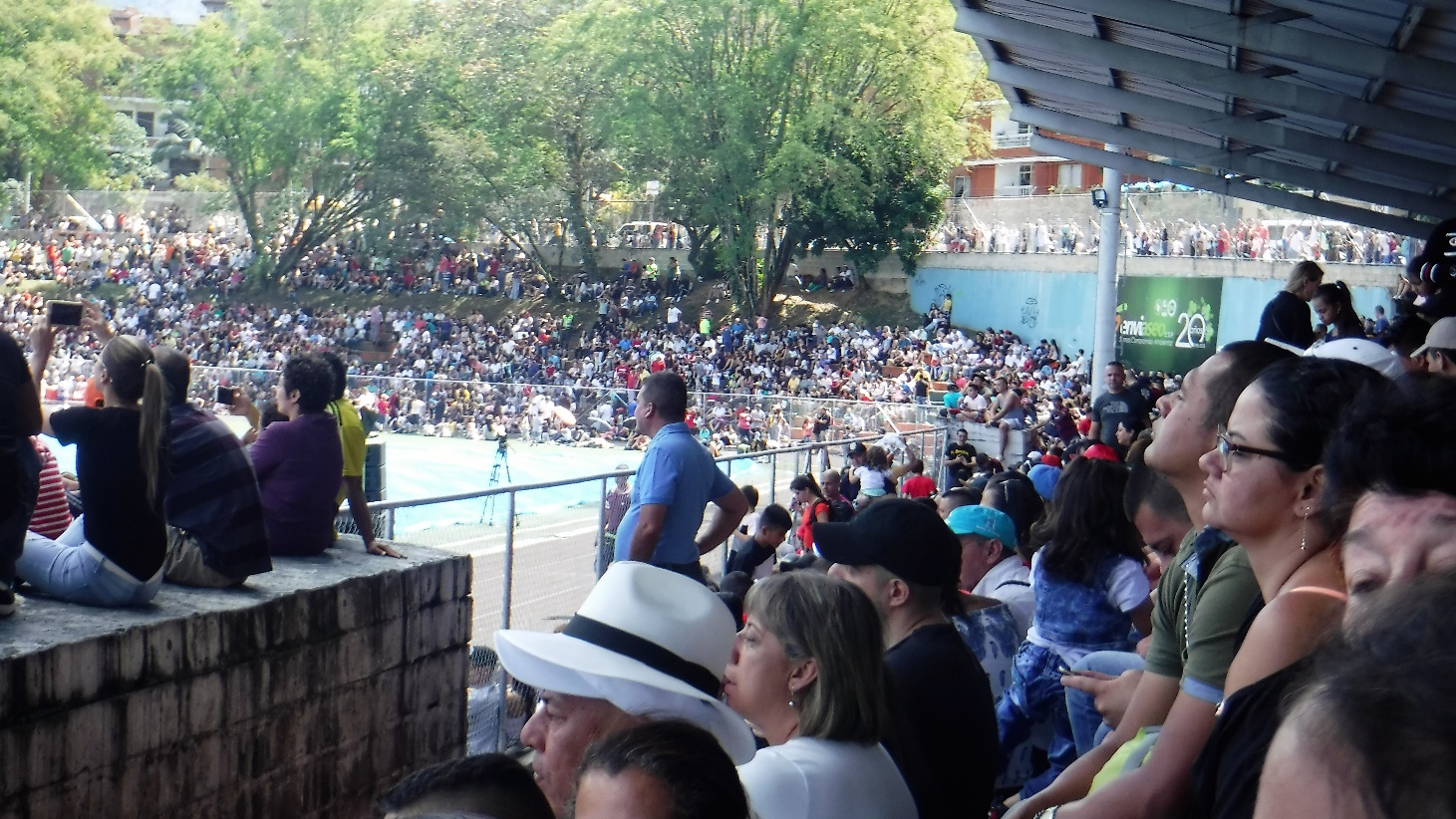 A group of people standing in front of a crowd Description automatically generated