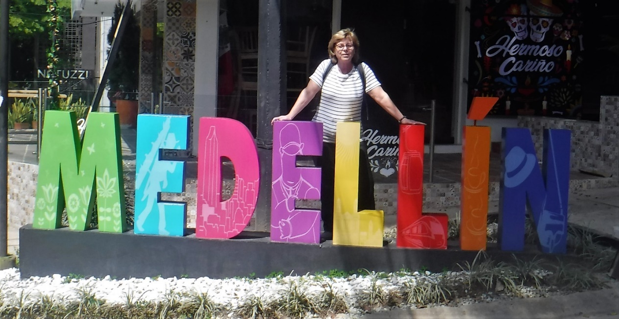 A person standing in front of a building Description automatically generated