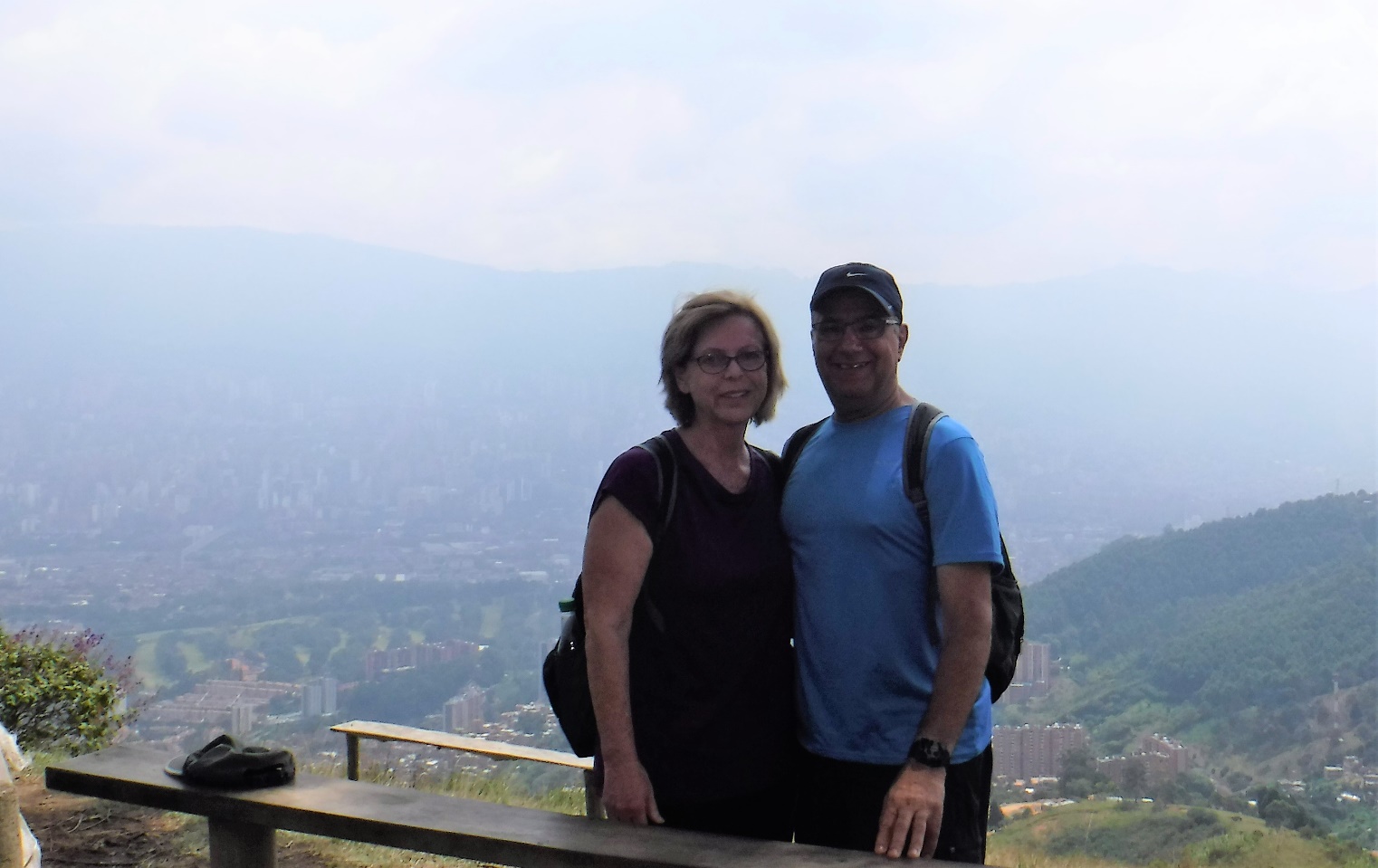 A person standing in front of a mountain Description automatically generated