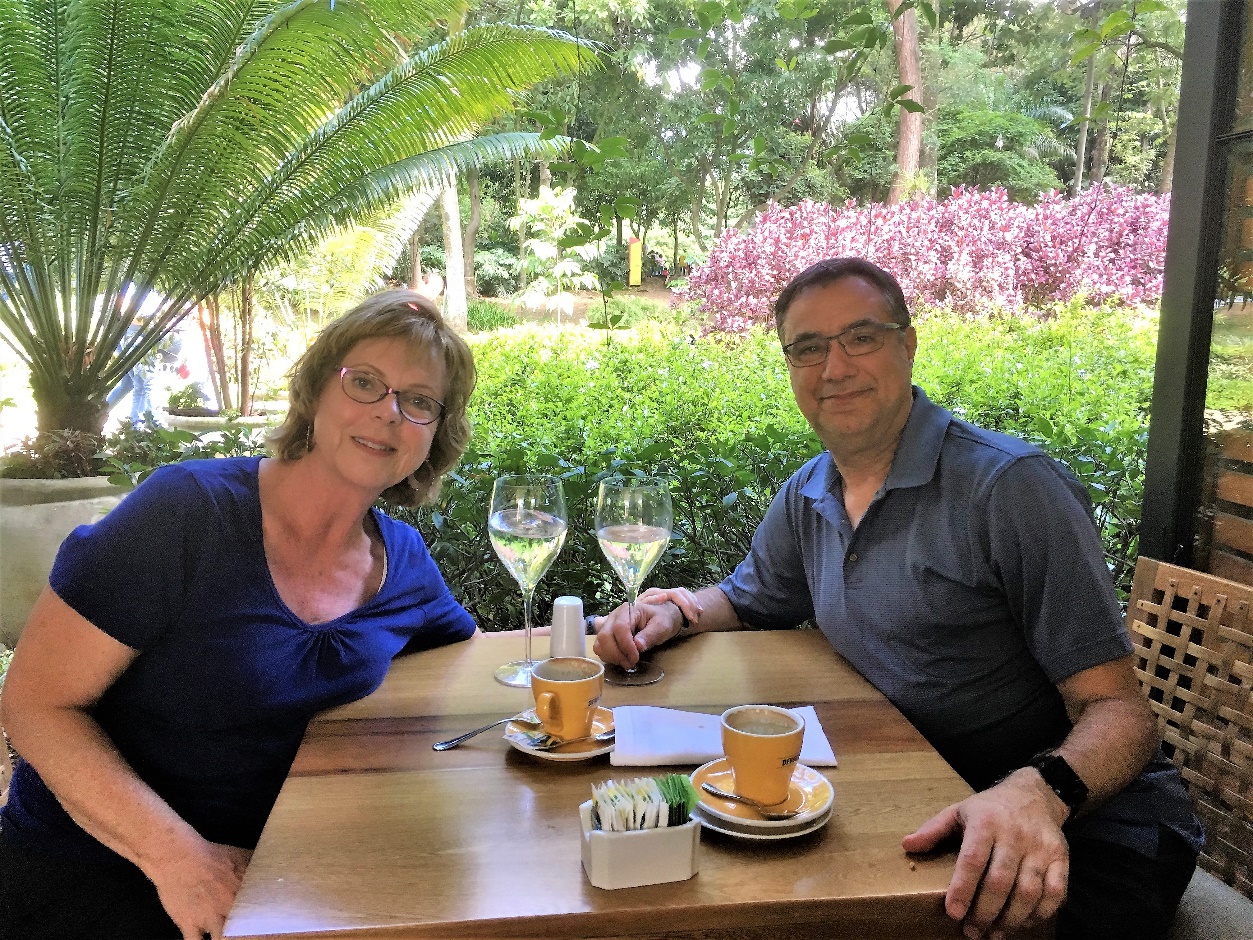 Two people sitting at a table Description automatically generated