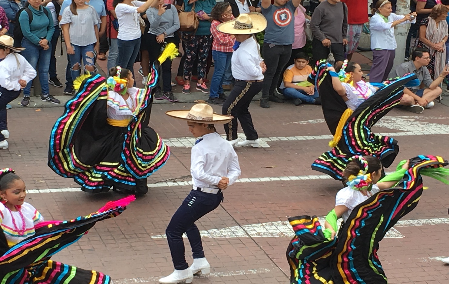A group of people standing in front of a crowd Description automatically generated