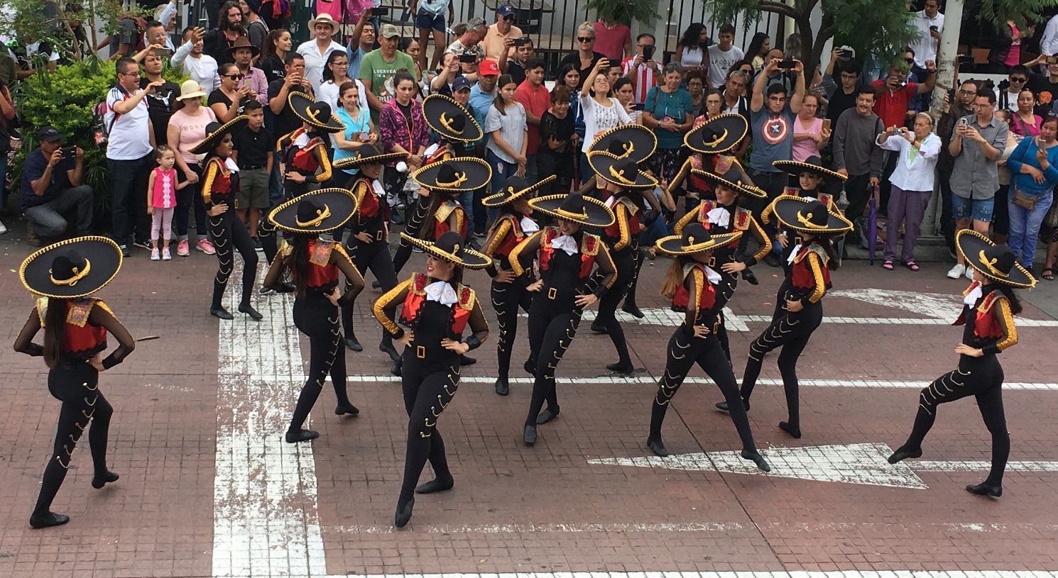A group of people walking in front of a crowd Description automatically generated