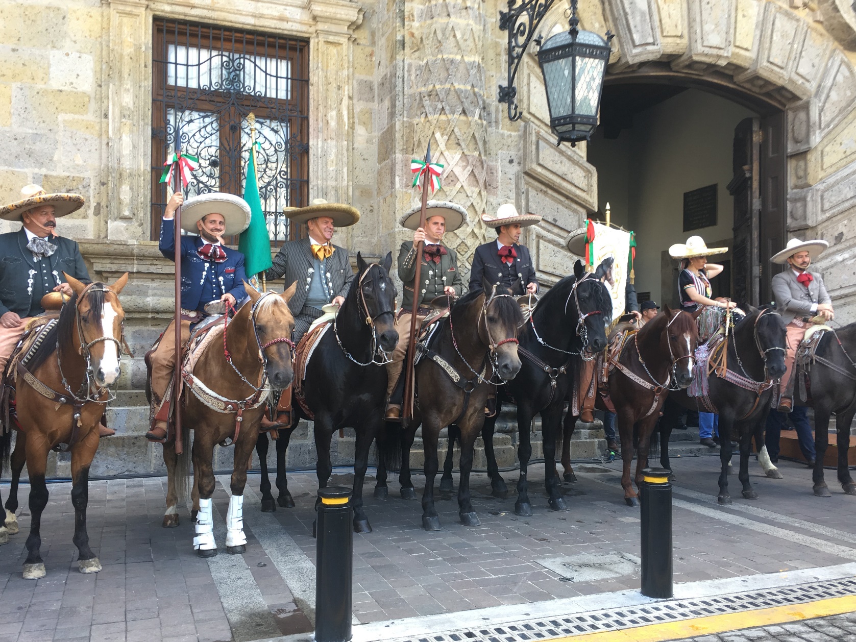 A group of police officers riding on the back of a horse Description automatically generated
