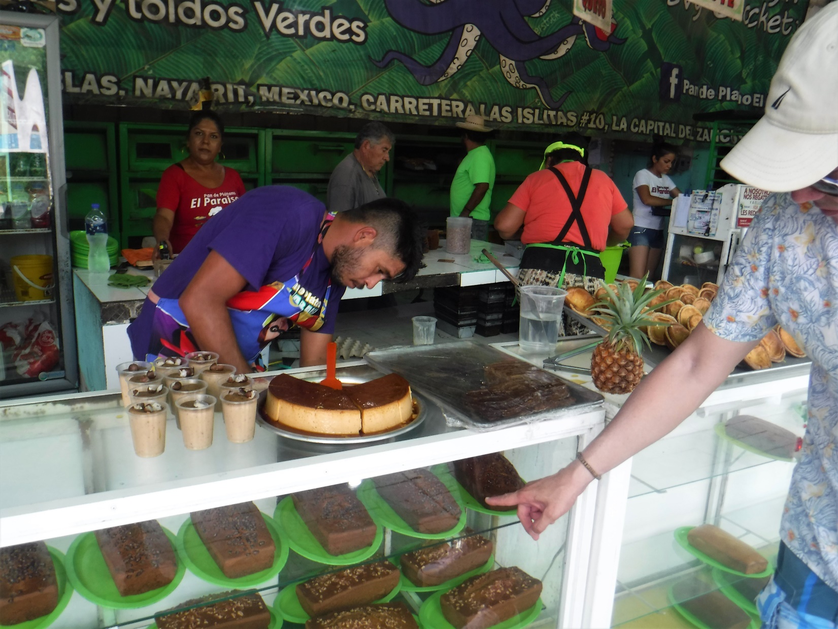 A group of people preparing food in a store Description automatically generated