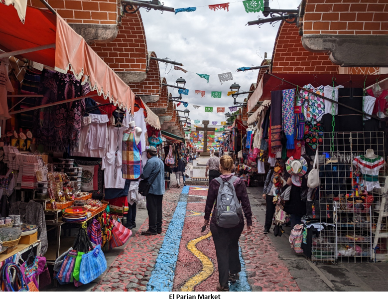 A picture containing text, outdoor, marketplace, people Description automatically generated