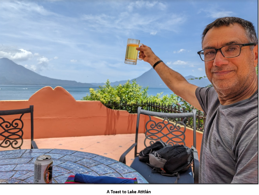 A person holding a glass of beer Description automatically generated