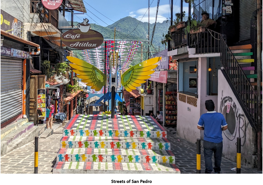 A person walking down a street with colorful stairs Description automatically generated