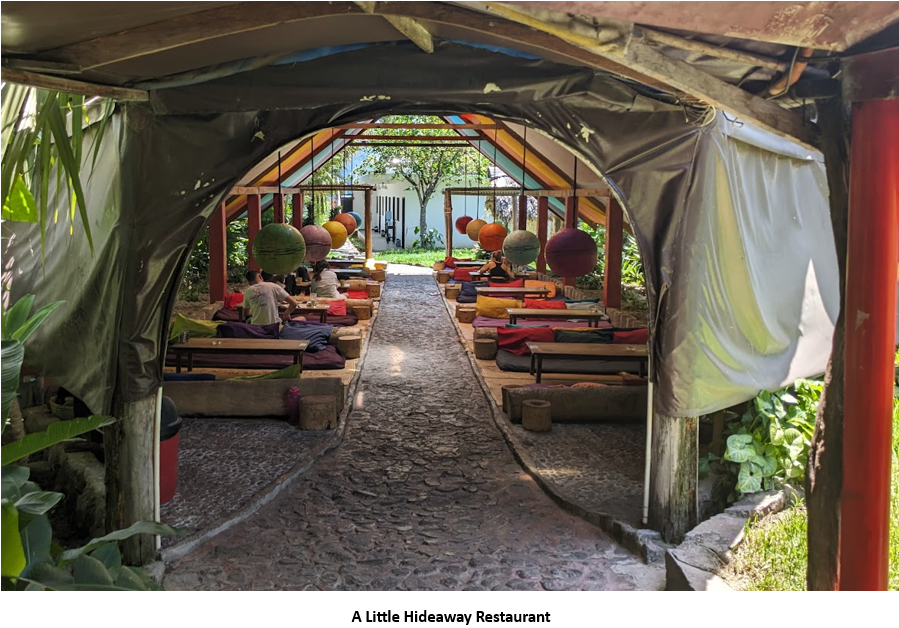 A tent with tables and benches Description automatically generated