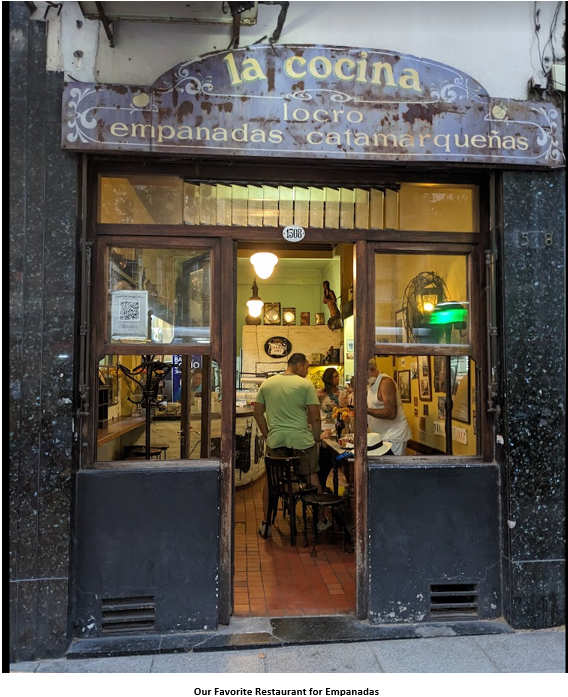 A person and person sitting at a table outside a restaurant Description automatically generated