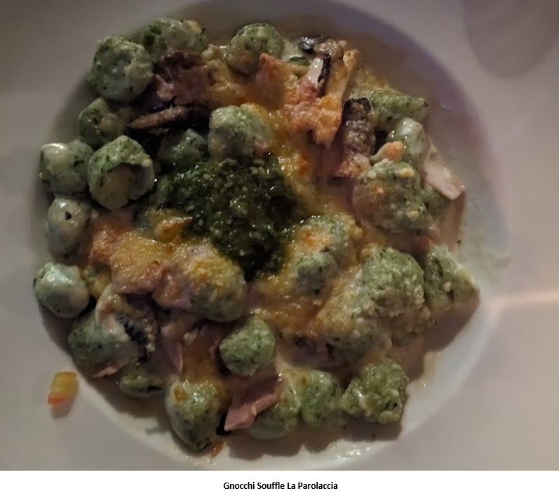 A plate of food with cheese and green sauce Description automatically generated