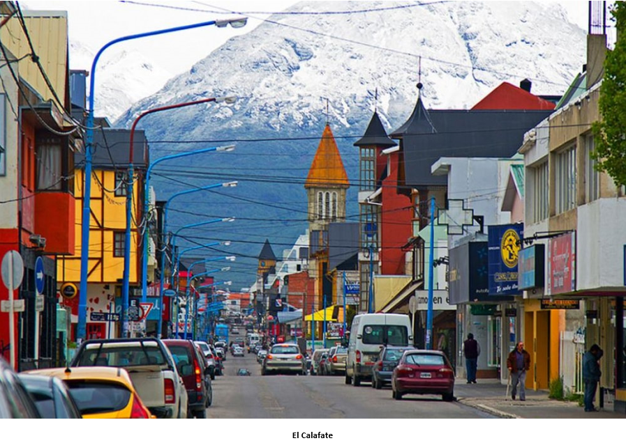 A street with cars and buildings in the background Description automatically generated