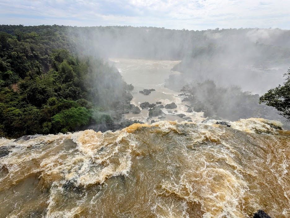 A waterfall with a lot of water and trees Description automatically generated with medium confidence