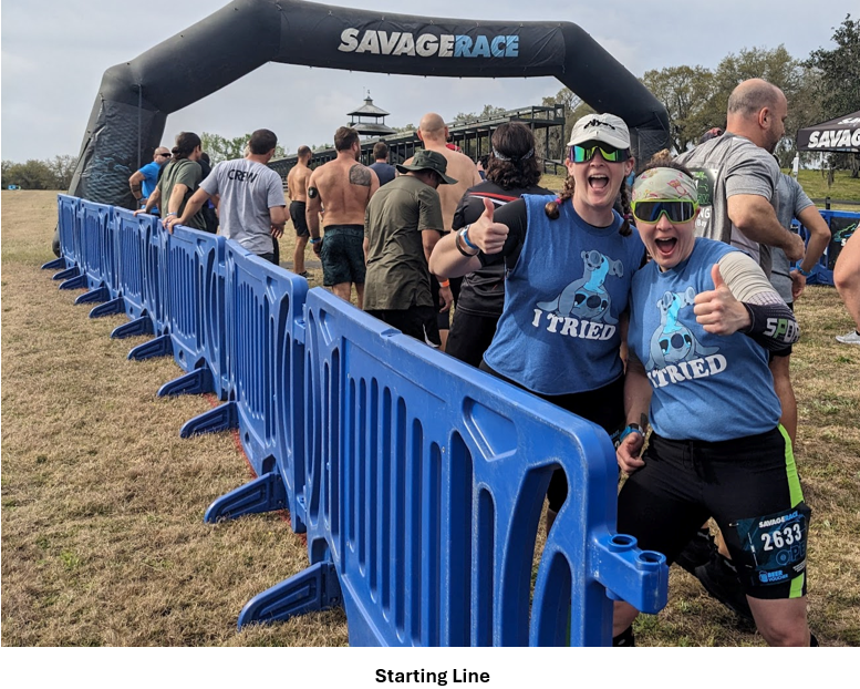 A group of people standing in front of a blue gate Description automatically generated