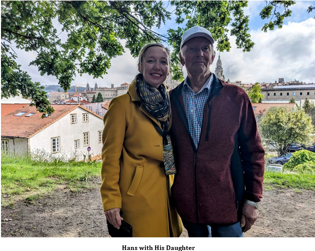 A person and person standing together under a tree Description automatically generated