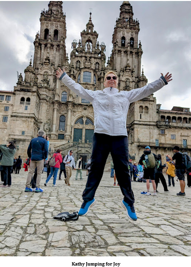 A person jumping in the air in front of a large building Description automatically generated