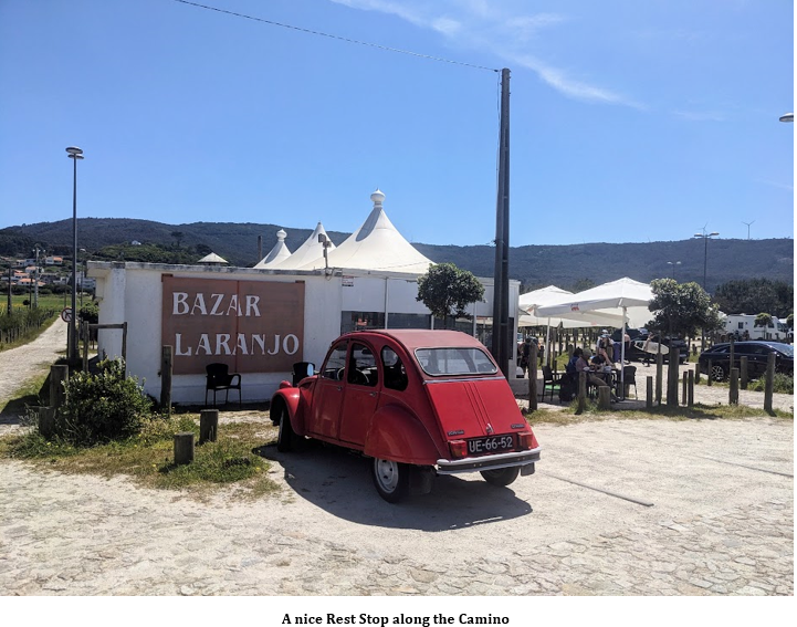 A red car parked in front of a building Description automatically generated