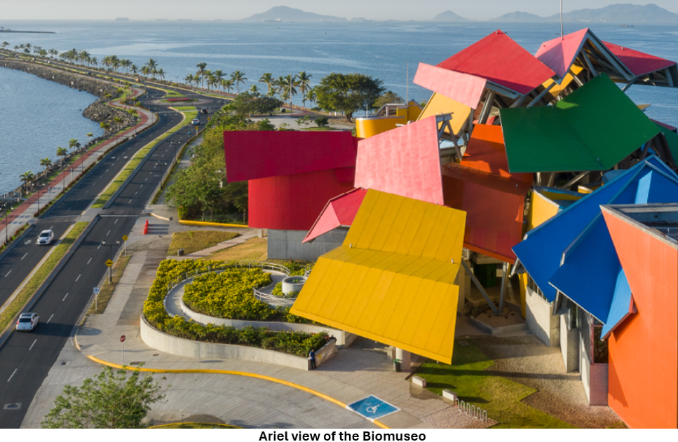 A multicolored building with a road and water in the background AI-generated content may be incorrect.